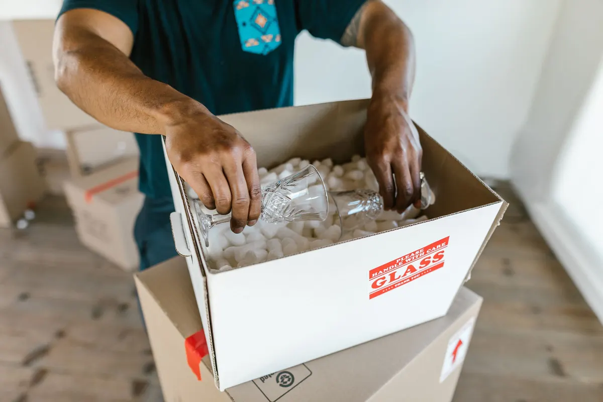 Crew member packing items into a box during a home cleanout